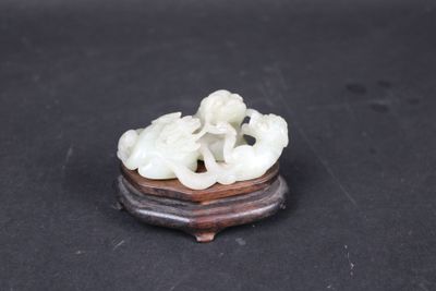 chinese carved jade figurine of two elephants on a wooden stand
