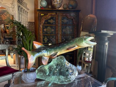 a statue of a fish on a table in a living room