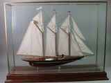 a model of a sailboat in a glass case