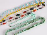 several necklaces and bracelets are displayed on a white surface