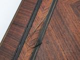 an image of a close up of a wooden table with a clock on top of it