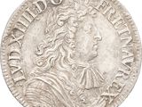 une pièce d'argent sur laquelle figure l'effigie d'un homme aux cheveux longs