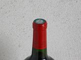 a bottle of wine sitting on a table next to a bottle of wine