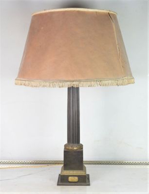 a lamp that is sitting on a table with a lamp shade on it