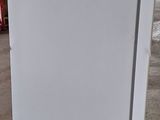 a white refrigerator sitting in the middle of a room