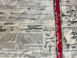 a quilt with a red border on it that has a picture of a man on a motorcycle
