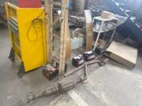 a lot of junk in a garage with a yellow cabinet