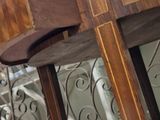 a wooden table with a mirror on it in a room
