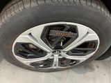 a close up of a car tire with a clock on it