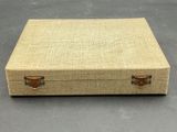 a close up of a suitcase on a table with a gray background