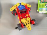 a toy car that is sitting on a table next to a package of toilet paper