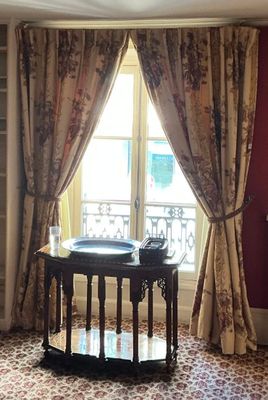 a living room with a couch and a table in front of a window