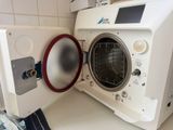 a white washer and dryer in a small room