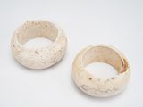two pieces of pottery sitting on a white surface