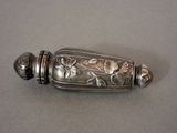 a silver object with flowers on it on a table