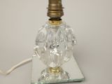 a glass lamp that is on top of a glass plate