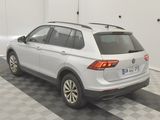 the back end of a white volkswagen suv parked in a garage