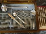 a wooden box with silverware in it on a table
