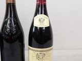 two bottles of wine sitting next to each other on a table