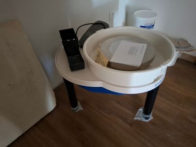 a white sink sitting on top of a wooden floor