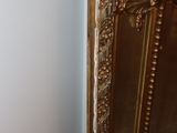 a gold cabinet in the corner of a room