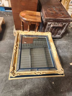 a table that has a mirror on it in the middle of a room