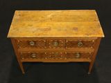 an image of a wooden chest of drawers on a black background