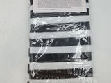 a black and white striped bag with a pair of scissors in it