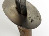 a metal object with a knife sticking out of it