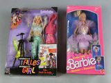two barbie dolls are sitting next to each other on a table