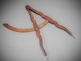 an old pair of scissors with a wooden handle on a gray background