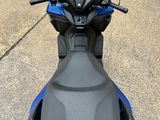 the back end of a motorcycle parked in a parking lot