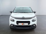 a white citrole car parked in a white room