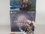 two figurines of god of war and a box of cards