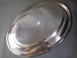 a silver tray with a silver lid on a table