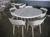 many chairs around a table in a room