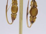 gold plated earrings with yellow glass beads on a gold plated stand