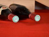 two bottles of wine sitting on a red table