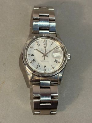 a silver watch with roman numerals on it
