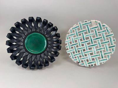 pair of black and white plates with a green center on a white background