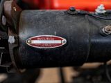 a close up of a motorcycle with a red and black background