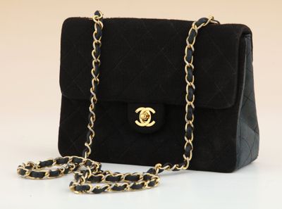 a close up of a black purse with a chain around it