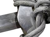 a close up of a knife with a rope on it