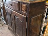 a large wooden cabinet with a vase on top of it