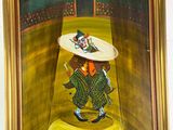 tableau représentant un clown avec un chapeau et une canne, dans un cadre doré