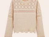 un pull blanc avec un motif au crochet sur les épaules