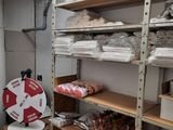 a room with a lot of shelves and boxes on it