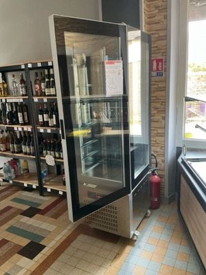 bottles of wine are on display in a store with tiled floors