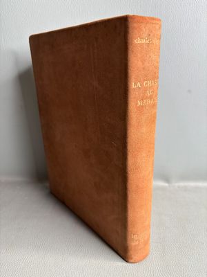 a brown book sitting on top of a table next to a white wall