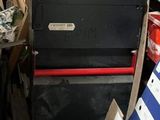 a stack of boxes in a storage room with many other items